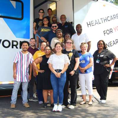 members of the mobile health and wellness program team pose with staff of the capital area health network