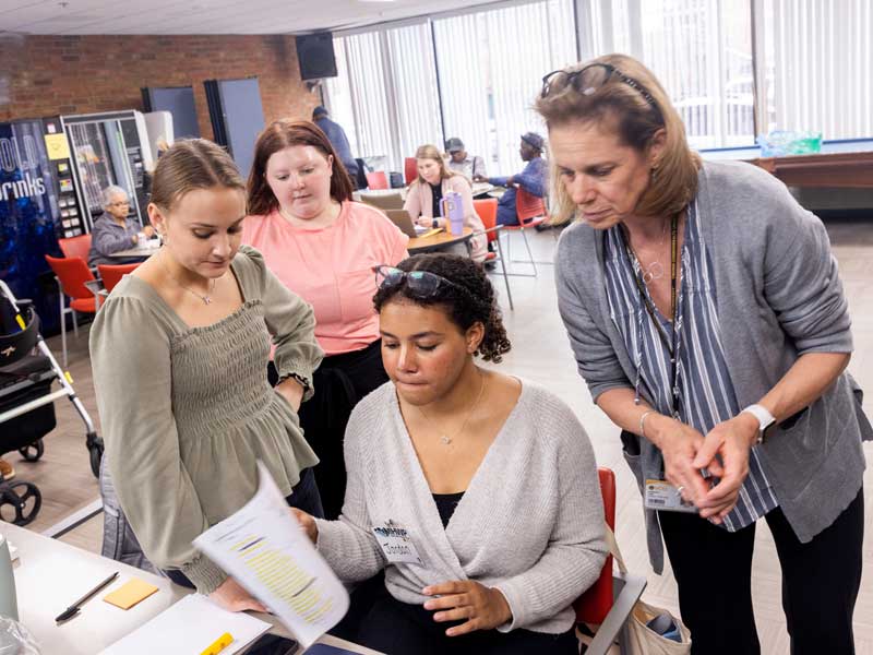 four people in a community health clinic looking at paperwork together