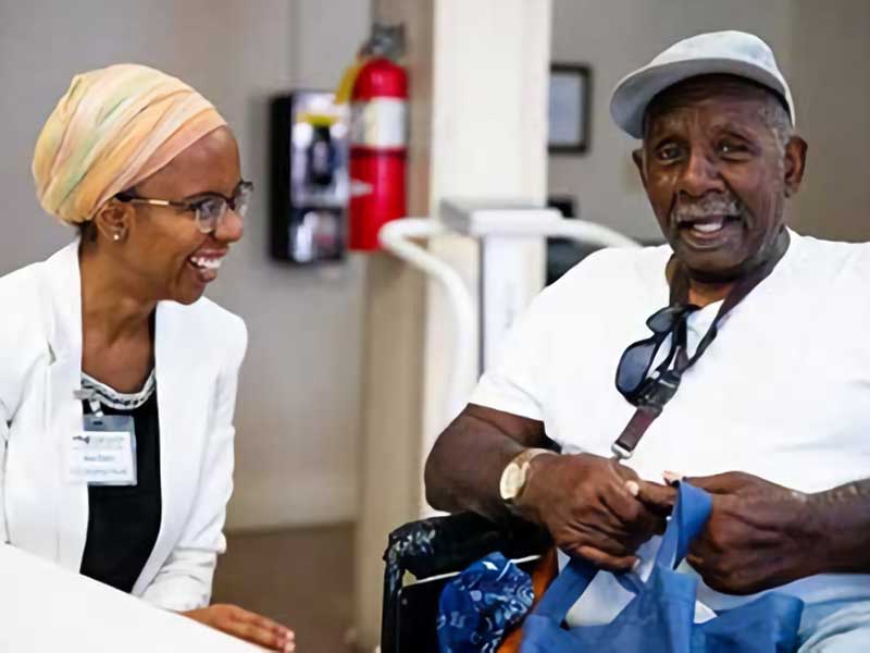 a health care worker enjoying a conversation with a patient in a clinic