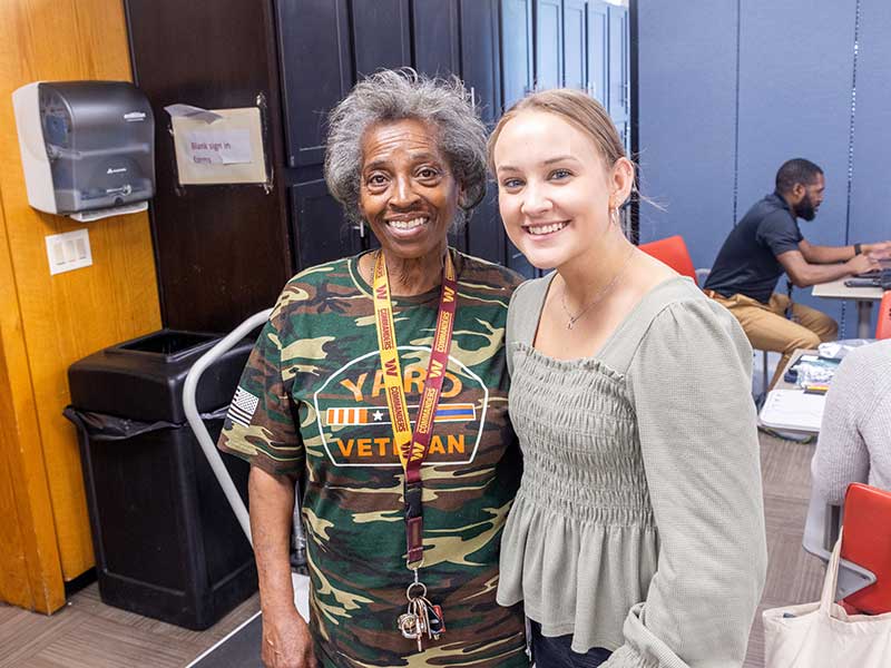 two people in a community health clinic smiling