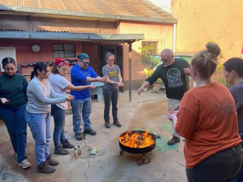 v.c.u. students and faculty participate in local traditions over an open fire
