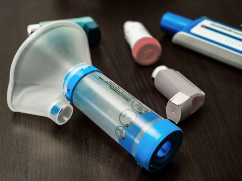 a young girl uses an inhaler